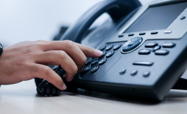 man-hand-point-to-press-button-number-on-telephone-office-desk_42708-288